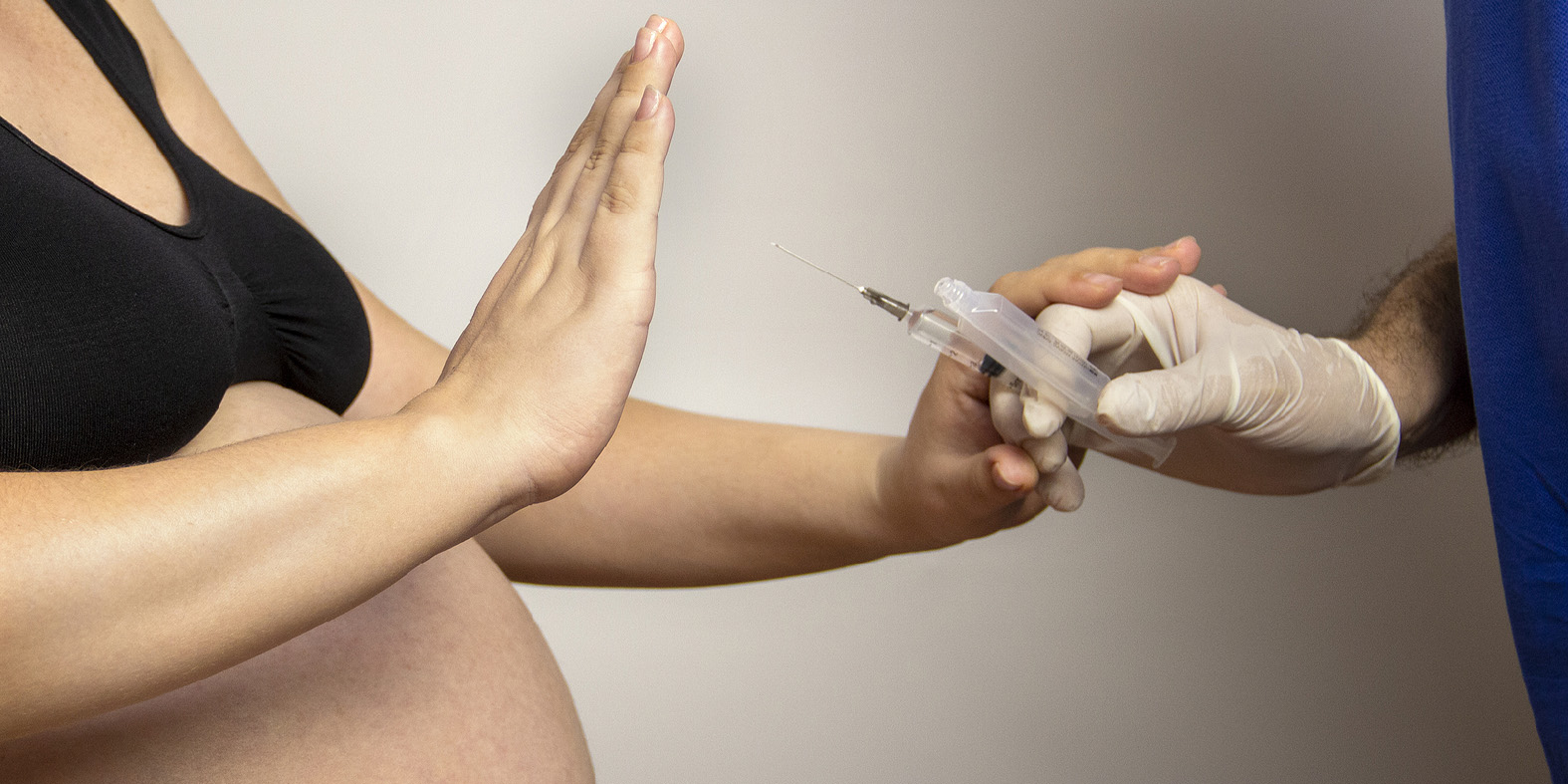 a doctor vaccinates a pregnant woman. Pregnancy against vaccination