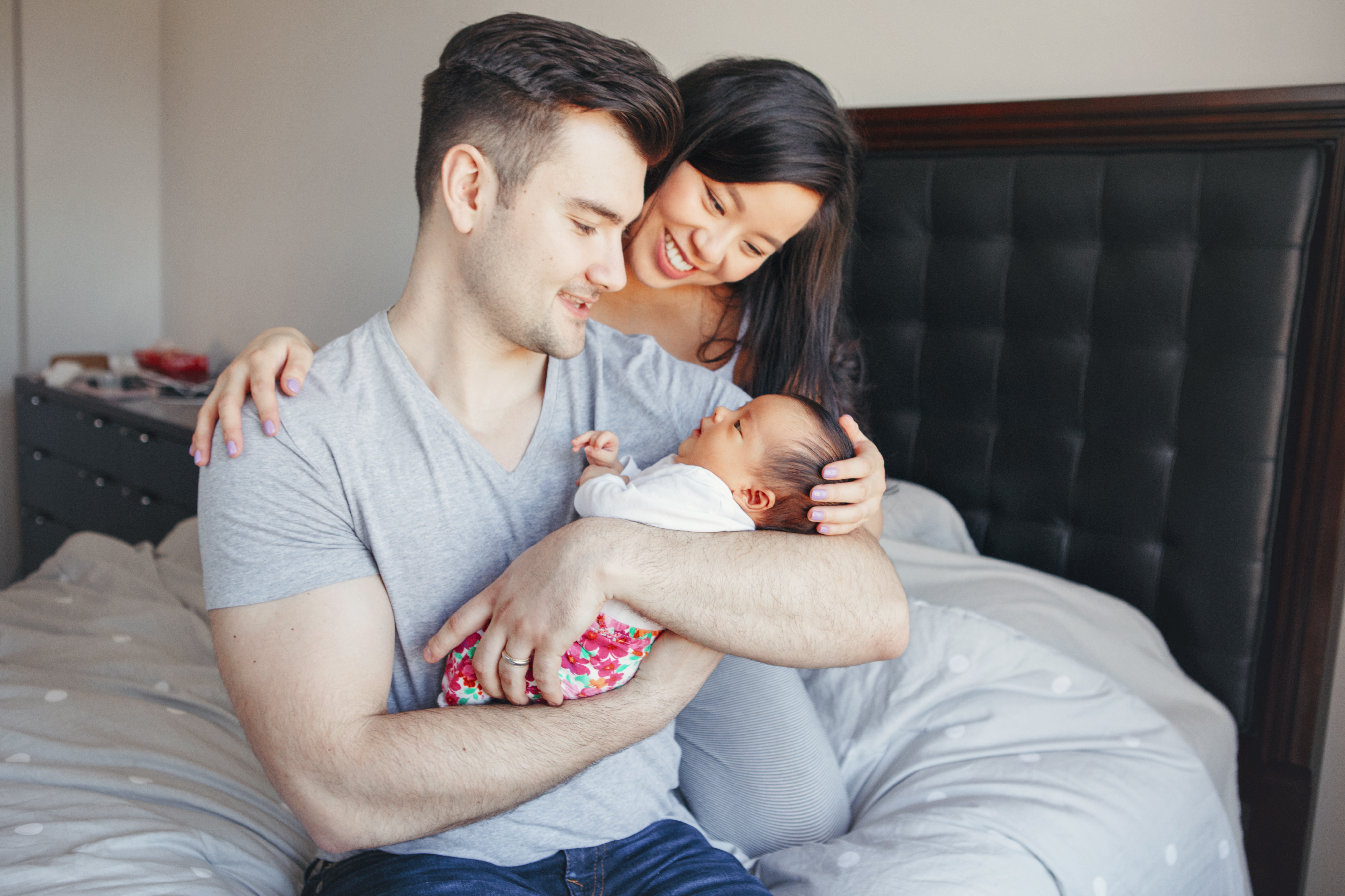 Couple cradle a newborn baby